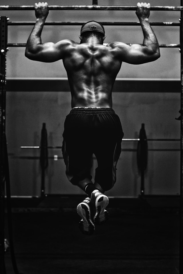 A person lifting weights in a gym, showcasing strength and fitness.